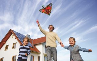 family with kite solar panel on roof